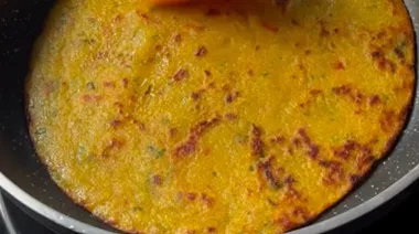 Liquid aloo paratha being cooked on tawa with golden crisp edges 4